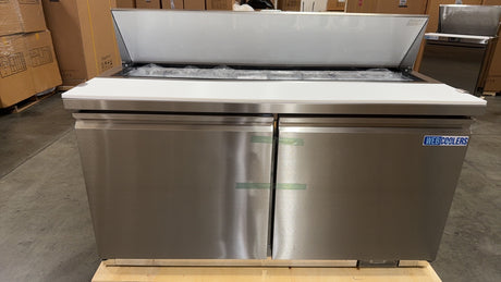 Stainless steel refrigerator on a wooden pallet in a warehouse setting