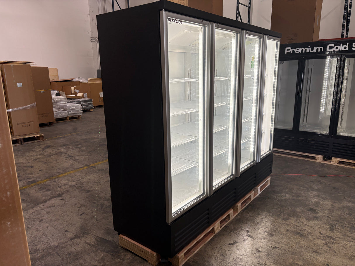 Large black refrigerator with glass doors in a warehouse setting