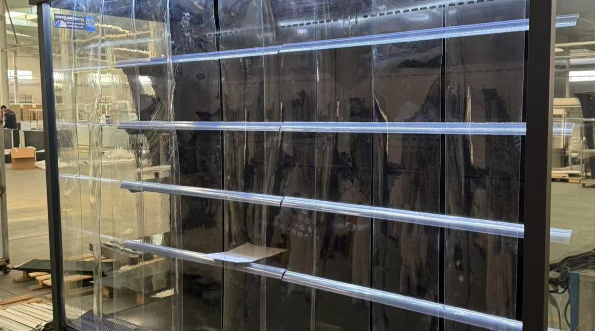 Large glass panel with metal frame in a warehouse setting