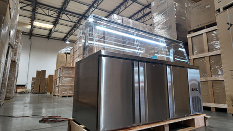 Open storage base of TG72'' prep table showing three adjustable polyethylene-coated shelves.