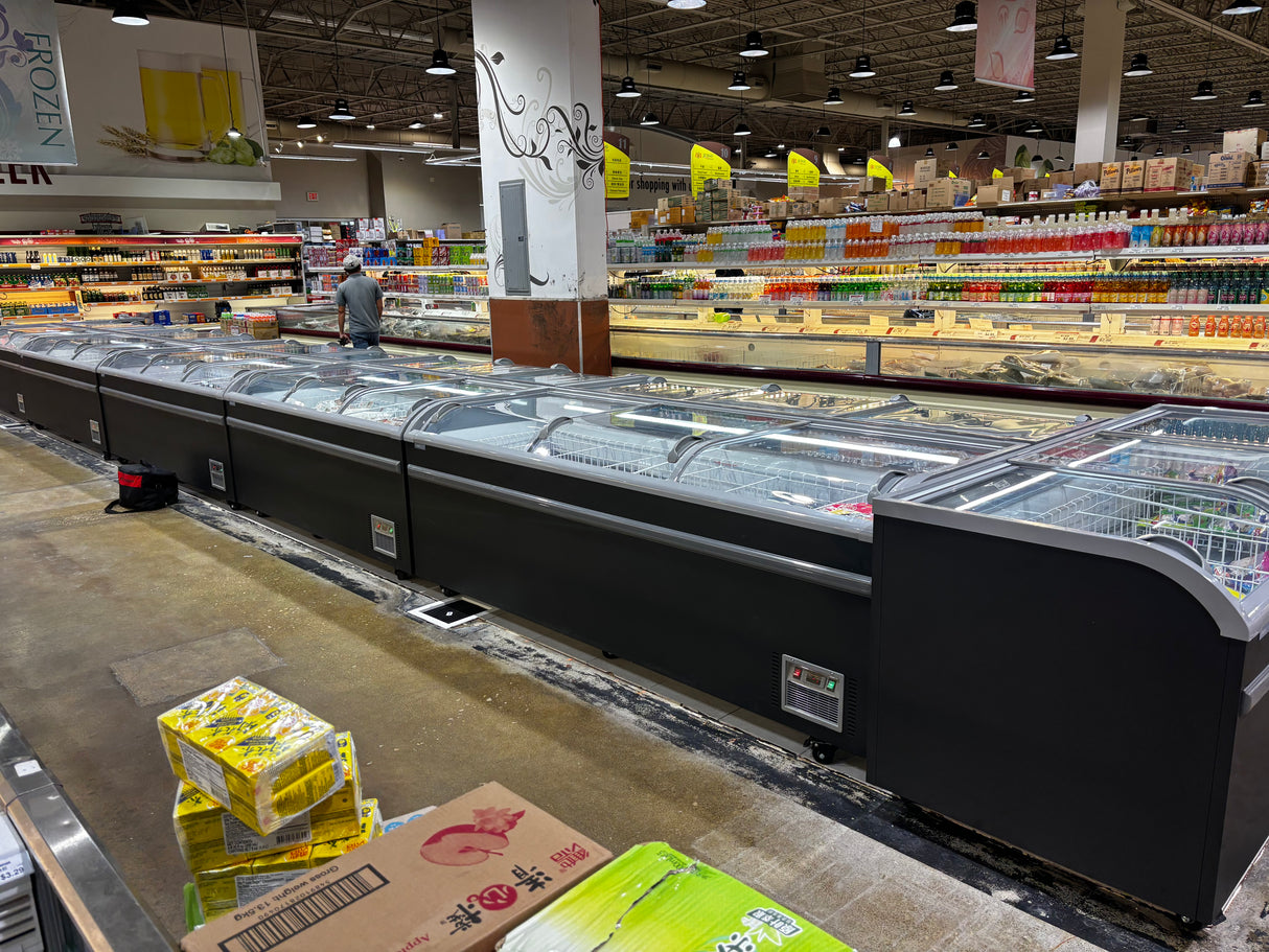 Supermarket interior with refrigerated display cases and shelves stocked with products.