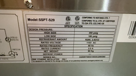 Technical label with specifications on a metallic surface