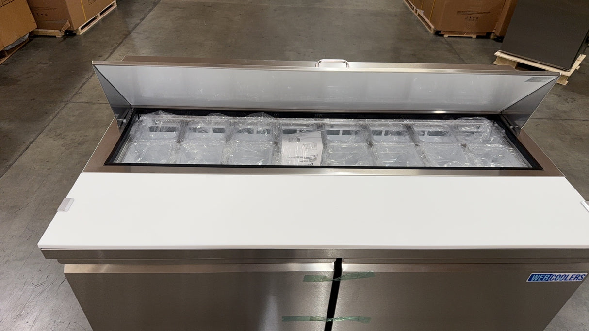 Stainless steel refrigerator with glass door in a warehouse setting