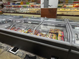 Frozen food display case in a grocery store with various products.