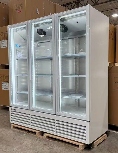 Large commercial freezer with glass doors on a pallet in a warehouse setting