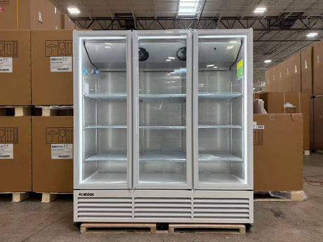Large industrial refrigerator in a warehouse setting with cardboard boxes around