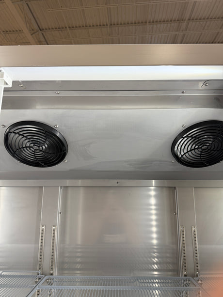 Metallic industrial unit with fans and shelves in a storage or warehouse setting