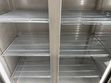 Empty metal shelves inside a refrigerator or freezer unit.