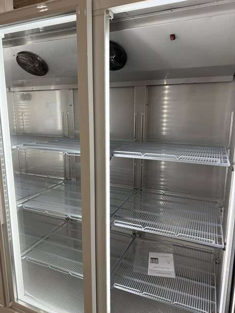 Two metal shelves inside a larger metallic enclosure, possibly a storage or industrial setting.