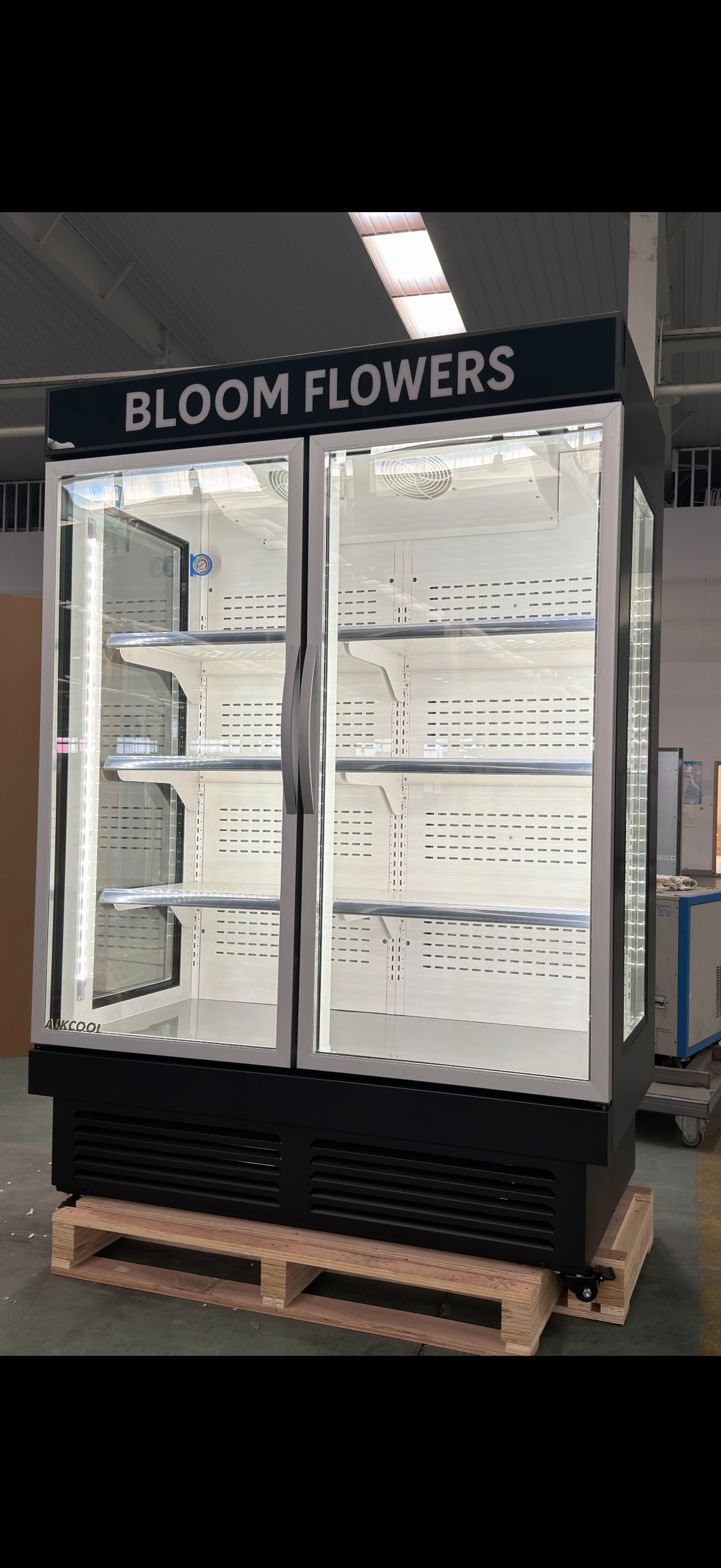 Bloom Flowers display freezer on a pallet with 'Bloom Flowers' branding.