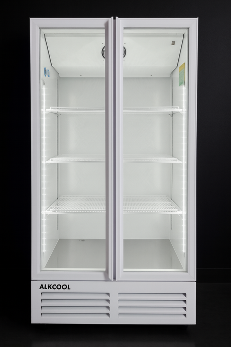 White refrigerator with glass doors on a black background