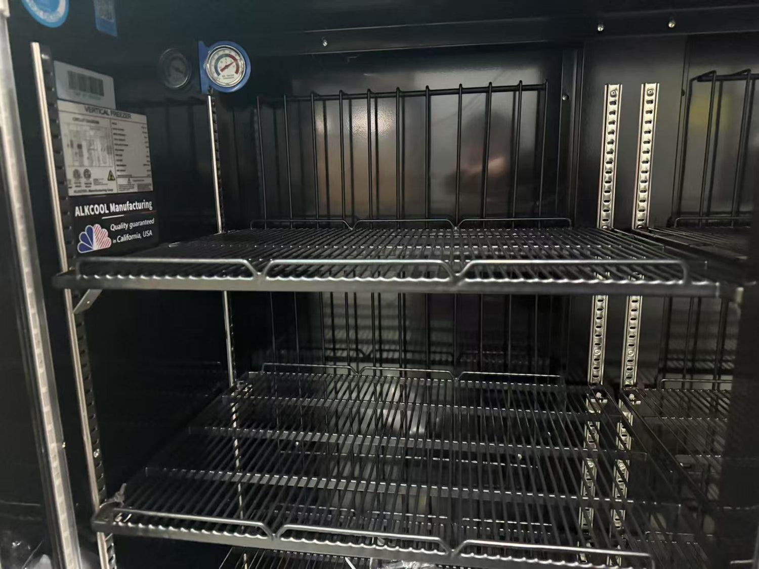 Commercial upright freezer with LED lighting, aluminum handle, and locking castors