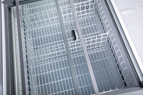 Commercial glass top freezer with two sliding doors and four wire baskets for frozen food