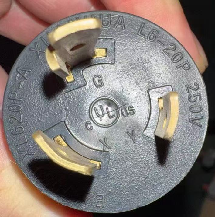 Electrical plug with UL certification held in a hand