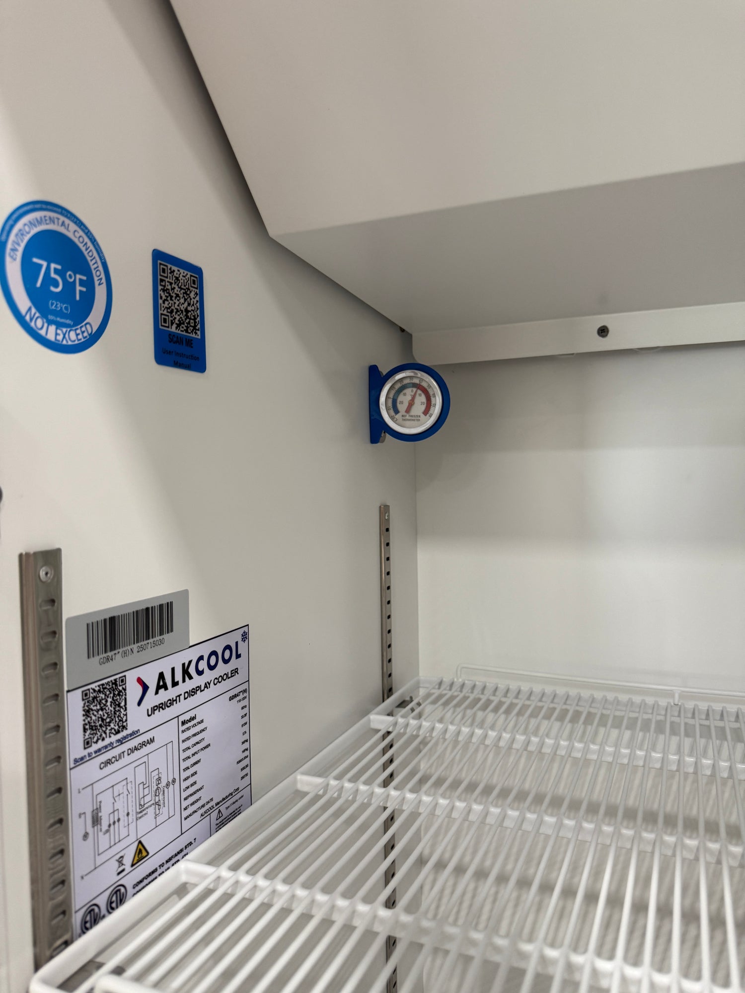 Product packaging with labels and a QR code on a white surface