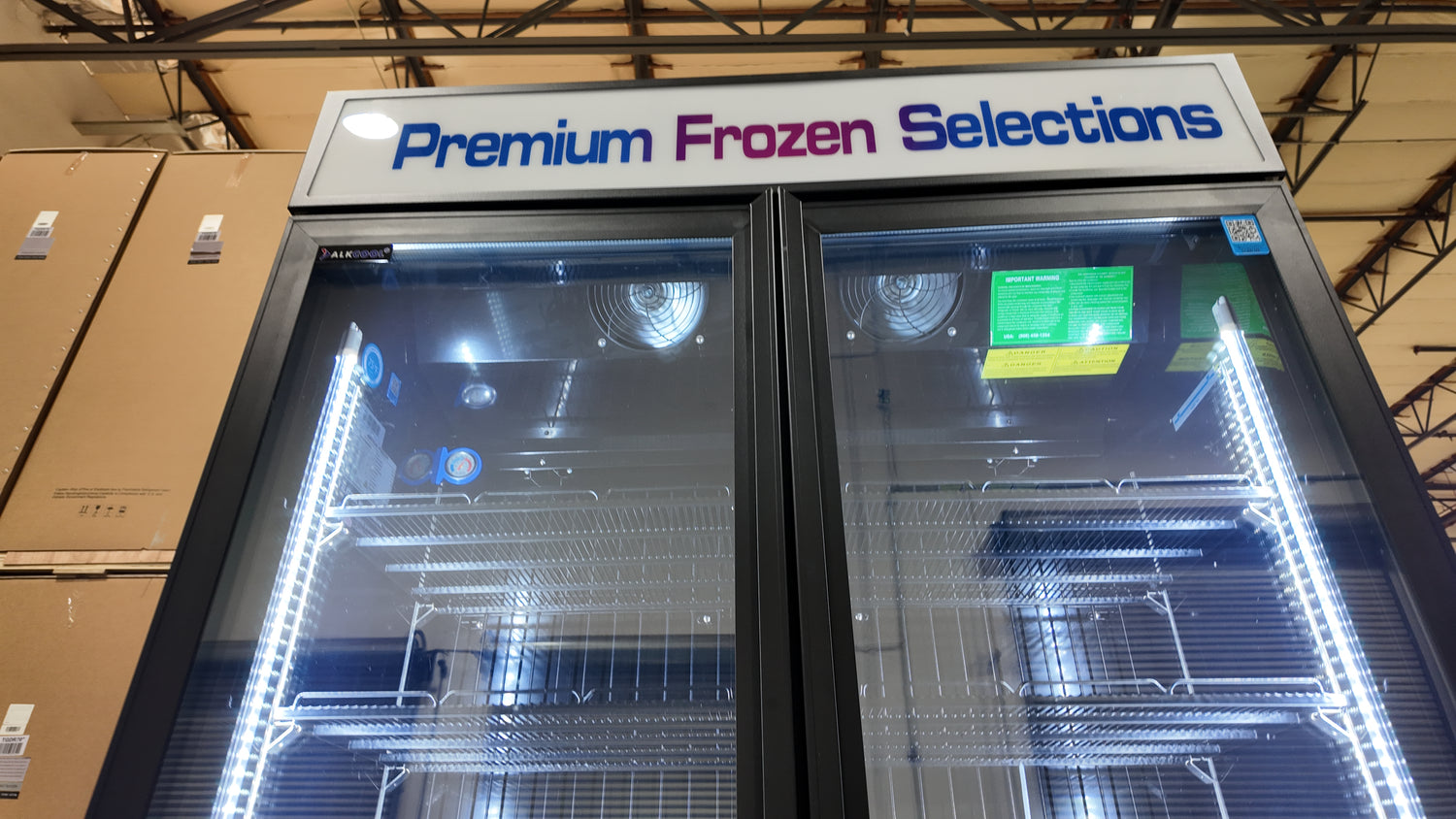 Frost-free glass door freezer with illuminated interior and durable castors