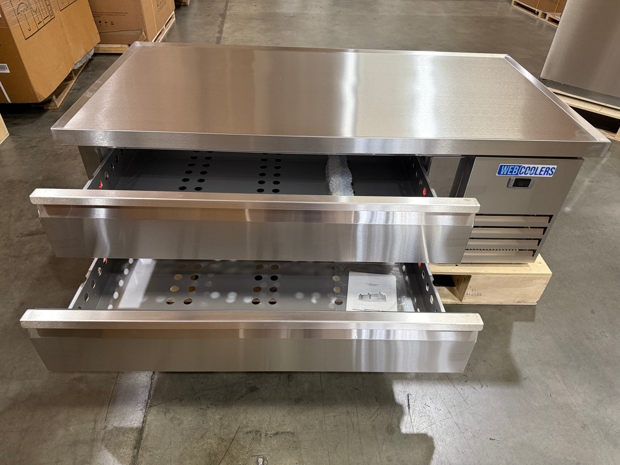 Stainless steel commercial oven with open door in a warehouse setting