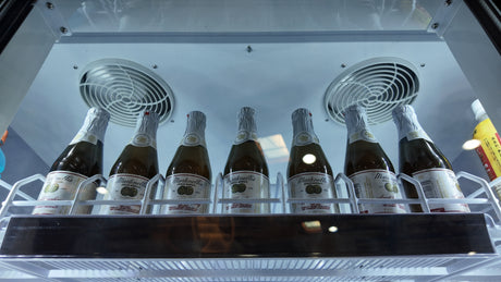 Backlit exterior top panel on NAFCOOL TGDR70 Black Swing Glass Cooler attracting customer attention